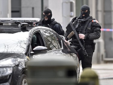 Special police secure the city center in Brussels, Belgium, Tuesday, March 22, 2016.  Authorities locked down the Belgian capital on Tuesday after explosions rocked the Brussels airport and subway system, killing  a number of people and injuring many more. Belgium raised its terror alert to its highest level, diverting arriving planes and trains and ordering people to stay where they were. Airports across Europe tightened security.