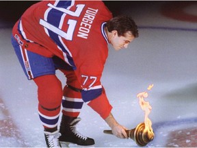 Former Canadiens captain Pierre Turgeon touches symbolic Forum torch to CH logo during 1996 Molson Centre opener.