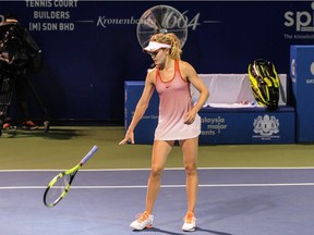 Eugenie Bouchard of Canada throws her racket during her final singles match at the BMW Malaysian Open women's tennis tournament against against Elina Svitolina of Ukraine in Kuala Lumpur on March 6, 2016.