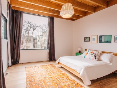 The master bedroom's ceiling has hemlock planks intersected and supported by hemlock beams.
Photo by Vivian Doan