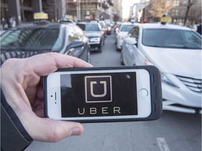 The Uber logo seen in front of protesting taxi drivers at the Montreal courthouse, on February 2, 2016.