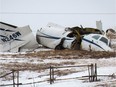 The wreckage of an airplane lies in a field Tuesday, March 29, 2016 in Havre-aux-Maison, Quebec.