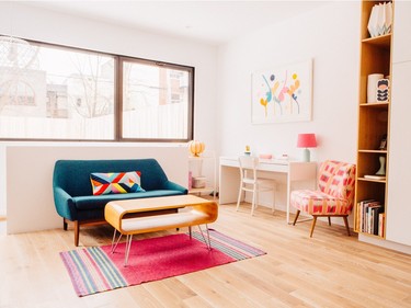 This area off the kitchen is within a ten by 17 foot extension added to the back of the house. The opening in the half-wall behind the couch leads downstairs to a 200 square foot basement with a heated concrete floor. Photo by Vivian Doan