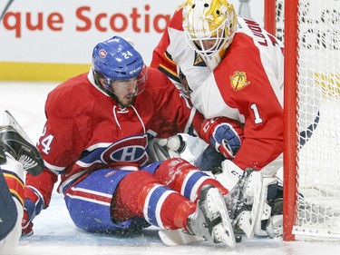 Phillip Danault slides into Florida Panthers goalie Roberto Luongo during first period in Montreal Tuesday, April 5, 2016.