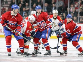 John Scott, left with linemates Torrey Mitchell, centre, and Paul Byron compete against Florida Panthers' Rocco Grimaldi, second from left, Jiri Hudler and Jakub Kindl during second period in Montreal on Tuesday, April 5, 2016.