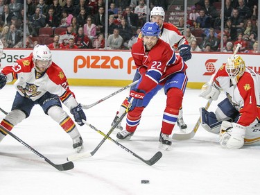 John Scott competes for the puck with Florida Panthers, from left, Brian Campbell, Rocco Grimaldi, Aaron Ekblad and goalie Robert Luongo during first period in Montreal on Tuesday, April 5, 2016.