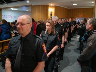 Firefighters arrive for a special commemorative mass in memory of the seven airplane crash victims at the Sainte-Madeleine de Havre-aux-Maisons church in Les Iles de la Madeleine on Tuesday, April 5, 2016.