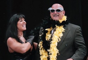 FILE - In this July 14, 1999 file photo, Minnesota Gov. Jesse Ventura is adorned with his signature feather boa and glitter sunglasses by professional wrestler Chyna, during a World Wrestling Federation press conference at the Target Center in Minneapolis. Chyna, the WWE star who became one of the best known and most popular female professional wrestlers in history in the late 1990s, has died at age 45. Los Angeles County coroner’s Lt. Larry Dietz says Chyna, whose real name is Joan Marie Laurer