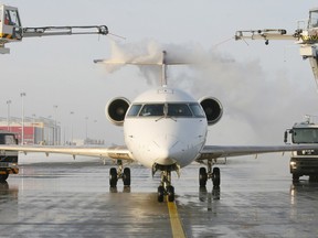 A Bombardier CRJ 900 airplane is de-iced at the Leipzig-Halle airport in the eastern German city of Schkeuditz on January 5, 2010. Winter weather continues in Germany causing travel delays with more snowfall forecast and very low temperatures for the next few days.