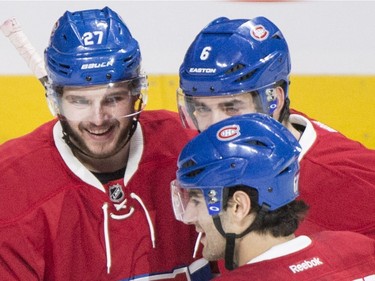 Canadiens' Alex Galchenyuk, left, celebrates with teammates Greg Pateryn (6) and Max Pacioretty (67) after scoring against the Tampa Bay Lightning during first period NHL hockey action in Montreal, Saturday, April 9, 2016.