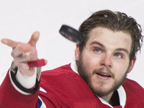 Canadiens' Alex Galchenyuk throws a puck to fans following the Canadiens win over the Tampa Bay Lightning in an NHL hockey game in Montreal, Saturday, April 9, 2016. Galchenyuk and Max Pacioretty each scored twice to reach the 30-goal mark for the season as the Montreal Canadiens ended their NHL regular season with a 5-1 victory over the Tampa Bay Lightning on Saturday, April 9, 2016.