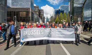 People hold a banner reading "Brussels #itsallofus" as they take part in the peaceful march "#Tousensemble - #Sameneen" against terrorism and hate in the city centre of Brussels on April 17, 2016.
