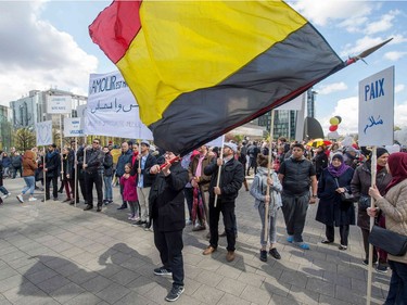 A man holds Belgium national flag as he takes part in the peaceful march "#Tousensemble - #Sameneen" against terrorism and hate in the city centre of Brussels on April 17, 2016.