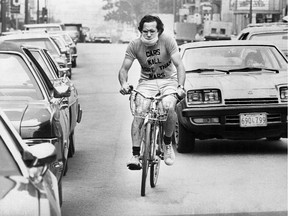 "Bicycle Bob" Silverman wears a mask while cycling in traffic in Montreal in 1976.