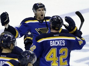 St. Louis Blues' Scottie Upshall and David Backes (42) celebrate after the Blues' 3-2 victory over the Chicago Blackhawks in Game 7 of an NHL hockey first-round Stanley Cup playoff series Monday, April 25, 2016, in St. Louis. The Blues won the series 4-3. (AP Photo/Jeff Roberson)