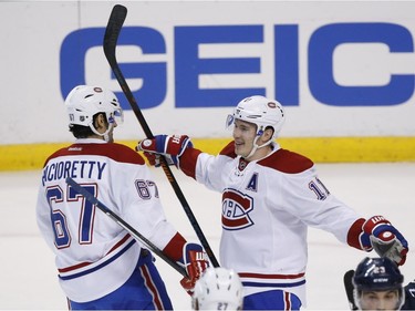 Montreal Canadiens right wing Brendan Gallagher (11) celebrates with left wing Max Pacioretty (67) after Gallagher scored during the first period of an NHL hockey game against the Florida Panthers, Saturday, April 2, 2016, in Sunrise, Fla.