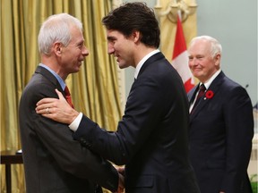 Canadian Prime Minister Justin Trudeau speaks with his Minister of Foreign Affairs Stephane Dion during a swearing-in ceremony at Rideau Hall in Ottawa on  November 4, 2015.