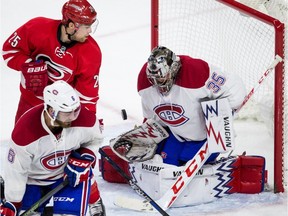 Montreal Canadiens goalie Charlie Lindgren (35) stops the puck as Carolina Hurricanes' Chris Terry (25) and Canadiens' Greg Pateryn (6) skate in front of the net during the third period of an NHL hockey game in Raleigh, N.C. Thursday, April 7, 2016. Montreal won 4-2.
