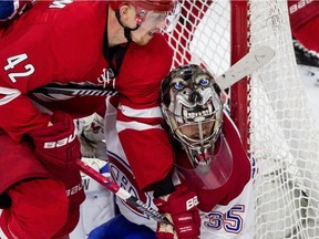 Montreal Canadiens goalie Charlie Lindgren (35) and Carolina Hurricanes' Joakim Nordstrom (42), of Sweden, work for position in front of the net during the third period of an NHL hockey game in Raleigh, N.C. Thursday, April 7, 2016. The Canadiens won 4-2.