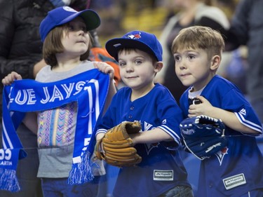 Chloe, 8, Zachary, 5, and Evan, 6, Thibault get ready to see the Toronto Blue Jays face the Boston Red Sox in spring training baseball action Friday, April 1, 2016, in Montreal.