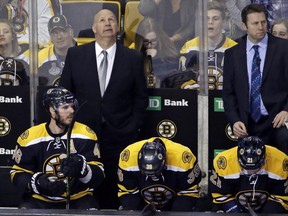 Boston Bruins head coach Claude Julien, left, stands behind Bruins centre David Krejci (46), left wing Matt Beleskey (39) and left wing Loui Eriksson (21) in the third period of an NHL hockey game against the Ottawa Senators, Saturday, April 9, 2016, in Boston. The Senators won 6-1.