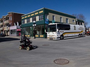 An SQ command post bus is parked at the intersection of Vaudreuil Avenue and des Cascades Street in St. Hyacinthe south of Montreal, Thursday April 14, 2016, as the provincial police reach out to the public for help in the double homicide of Martin Bélair and Nancy Beaulieu a year ago.