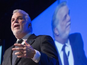 Quebec Premier Philippe Couillard addresses the opening of an aerospace conference on Monday, April 25, 2016, in Montreal.