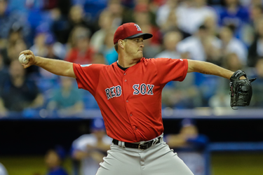 Boston Red Sox starting pitcher Steven Wright winds up for a pitch during of their exhibition game against the Toronto Blue Jays at the Olympic Stadium in Montreal on Friday, April 1, 2016.