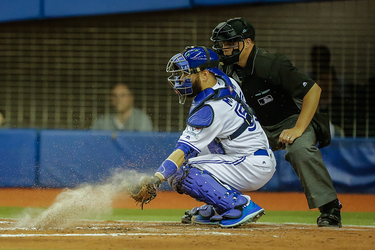 Toronto Blue Jays catcher Russell Martin misses a catch during the first inning of their exhibition game against the Boston Red Sox at the Olympic Stadium in Montreal on Friday, April 1, 2016.