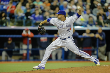 Toronto Blue Jays pitcher Chad Girodo makes a pitch during the eighth inning of their exhibition game against the Boston Red Sox at the Olympic Stadium in Montreal on Friday, April 1, 2016.