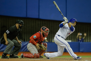 Toronto Blue Jays catcher Josh Thole, right, misses the ball on a strike as the ball bounces to Boston Red Sox catcher Sandy Leon, left, during their exhibition game at the Olympic Stadium in Montreal on Friday, April 1, 2016.