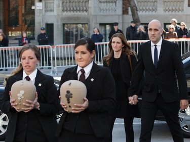 Jean Lapierre's daughter Marie-Anne Lapierre, rear left, and her spouse Mathieu Belhumeur, rear right, follow the urns as they arrive for the second funeral of former MP and media personality Jean Lapierre and his wife Nicole Beaulieu at Saint-Viateur-d'Outremont church in Montrealon Saturday, April 16, 2016. The couple died on March 29 in an airplane crash along with Lapierre’s siblings Louis Lapierre, Marc Lapierre, and Martine Lapierre as well as pilots Pascal Gosselin and Fabrice Labourel. The group was heading to Les Iles-de-la-Madeleine for the funeral of their father Raymond Lapierre.
