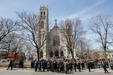 A crowd gathers outside the Saint-Viateur-d'Outremont church after the funeral service for former MP and media personality Jean Lapierre and his wife Nicole Beaulieuin Montreal on Saturday, April 16, 2016. The couple died on March 29 in an airplane crash along with Lapierre’s siblings Louis Lapierre, Marc Lapierre, and Martine Lapierre as well as pilots Pascal Gosselin and Fabrice Labourel. The group was heading to Les Iles-de-la-Madeleine for the funeral of their father Raymond Lapierre.