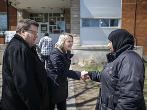 Christine Black, centre, who was running for Equipe Denis Coderre in Montreal North, and Montreal Mayor Denis Coderre greet a voter outside Saint-Vincent-Marie elementary school on voting day Sunday, April 24, 2016. Black won the race by a wide margin, capturing almost 70 per cent of the votes,