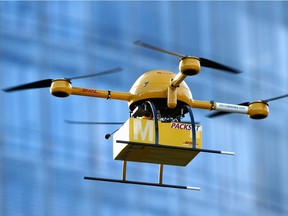 A quadcopter drone arrives with a small delivery at Deutsche Post headquarters in 2013 in Bonn, Germany.