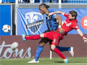 Toronto FC defender Drew Moor stretches to knock the ball away from Montreal Impact forward Didier Drogba during first half MLS action Saturday, April 23, 2016, in Montreal.