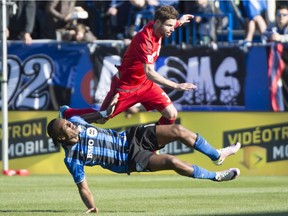 Impact forward Didier Drogba takes a hit from TFC's Drew Moor on April 23, 2016, in Montreal. Drogba played a full 90 minutes against Toronto and, while he was on the receiving end of some physical play, he said he felt good Monday.