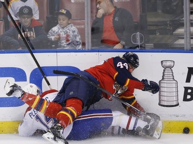 Florida Panthers defenseman Erik Gudbranson and Montreal Canadiens centre Tomas Plekanec  go down as they battle for the puck during the first period of an NHL hockey game, Saturday, April 2, 2016, in Sunrise, Fla.