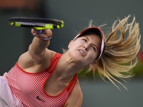Eugenie Bouchard, of Canada, serves to Timea Bacsinszky, of Switzerland, at the BNP Paribas Open tennis tournament, Monday, March 14, 2016, in Indian Wells, Calif.