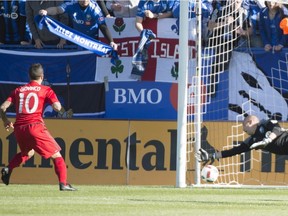 Toronto FC forward Sebastian Giovinco scores past Montreal Impact goalkeeper Evan Bush on a penalty shot during first half MLS action Saturday, April 23, 2016, in Montreal.