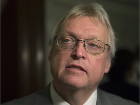 Quebec Health Minister Gaétan Barrette responds to reporters' questions after a caucus meeting, Tuesday, April 12, 2016 at the legislature in Quebec City.