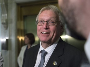 Quebec Health Minister Gaétan Barrette responds to reporters questions after a party caucus meeting, Wednesday, April 27, 2016 at the legislature in Quebec City.