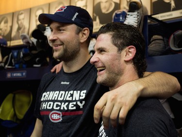 John Scott, left, poses for a picture with Mike Brown in the locker room after a team practice at the Bell Sports Complex in Montreal on Monday, April 4, 2016.