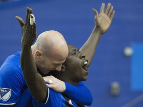Montreal Impact's Hassoun Camara, right, celebrates with teammate Laurent Ciman after scoring against the Columbus Crew SC during second half MLS soccer action in Montreal, Saturday, April 9, 2016.