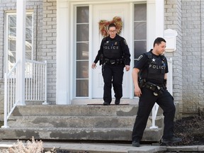 Police officers leave a house where convicted killer Karla Homolka lives, according to some media reports, in Chateauguay, Que., Wednesday, April 20, 2016.Reports that Homolka has resurfaced southwest of Montreal are creating a buzz in the town of Chateauguay.