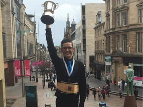 Irish dancer Lucas Lawton lifts his World Championship trophy in Glasgow Scotland, March 27, 2016. The 22-year-old from Dorval now has podium finishes at all five major competitions on the circuit. Photo courtesy of Bernadette Short.