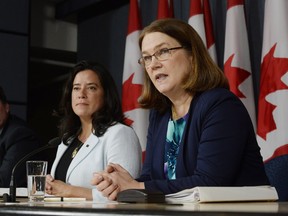 Health Minister Jane Philpott, right, speaks as Justice Minister Jody Wilson-Raybould looks on at a news conference in Ottawa on Thursday, April 14, 2016. The federal government has introduced a long-awaited and controversial new law spelling out the conditions in which seriously ill or dying Canadians may seek medical help to end their lives.The legislation says there should be a choice of medically assisted death "for adults who are suffering intolerably and for whom death is reasonably foreseeable."