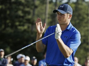 Jordan Spieth indicates how far he miss a putt for par on the 17th green on the during the second round of the Masters golf tournament Friday, April 8, 2016, in Augusta, Ga.