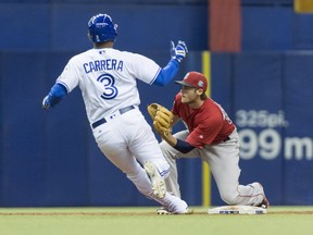 Toronto Blue Jays' Ezequiel Carrera is tagged out stealing second by Boston Red Sox second baseman Josh Rutledge during fourth inning in a spring training baseball game, Saturday, April 2, 2016, in Montreal.