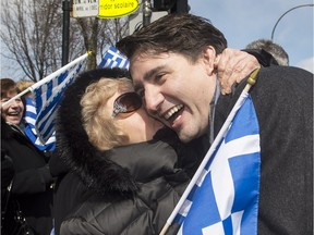 Prime Minister Justin Trudeau is hugged by a member of the crowd as he attends the Greek Independence Day parade in Montreal, Sunday, April 3, 2016.